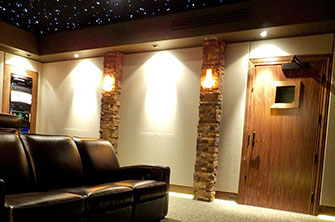 Home Theater with Soundproof Door, Stone Veneer on Columns, and Star Ceiling